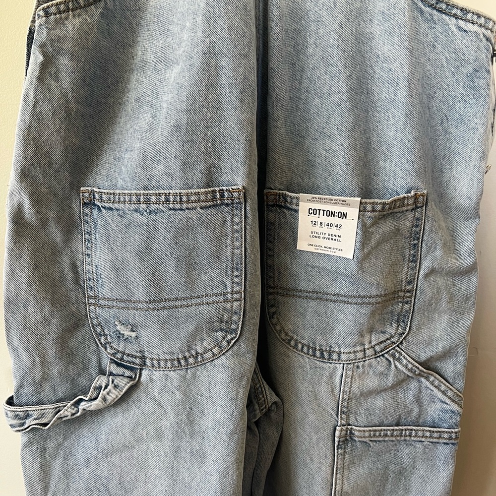 Distressed denim overalls